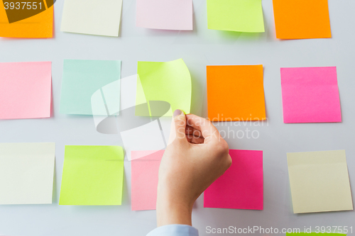 Image of close up of hand pointing to sticker on flip chart