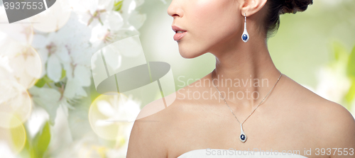 Image of close up of woman with earring and pendant