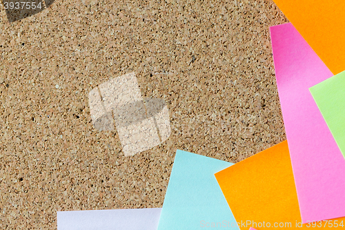 Image of close up of blank paper stickers on cork board