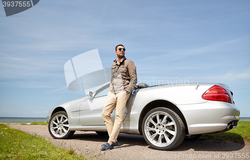 Image of man near cabriolet car outdoors