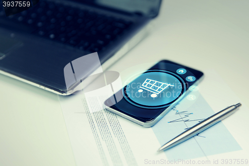 Image of close up of smartphone with shopping cart icon