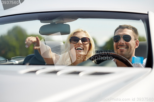 Image of happy man and woman driving in cabriolet car