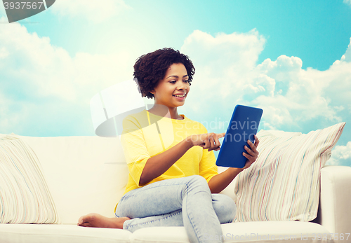 Image of happy african american woman with tablet pc