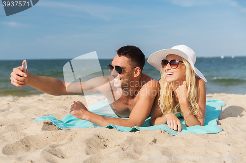 Image of happy couple in swimwear walking on summer beach