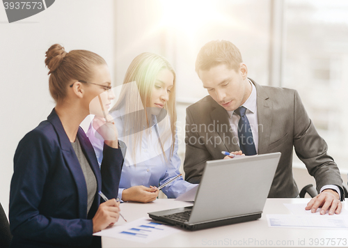 Image of business team with laptop having discussion