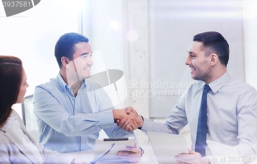 Image of business team working with tablet pc in office