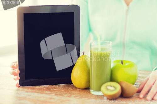Image of close up of woman hands tablet pc and fruit juice