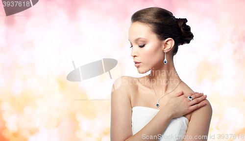 Image of beautiful woman with earring, ring and pendant