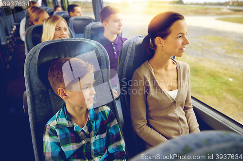 Image of happy family riding in travel bus