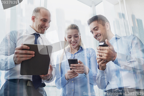 Image of business people with tablet pc and smartphones