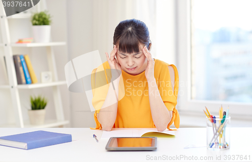 Image of tired asian woman student with tablet pc at home