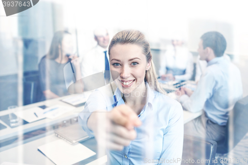 Image of group of smiling businesspeople meeting in office