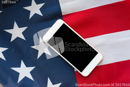 Image of close up of smartphone on american flag