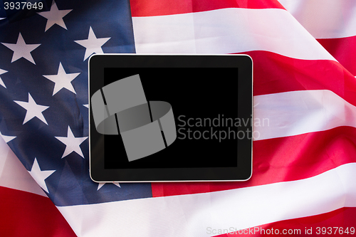 Image of close up of tablet pc computer on american flag