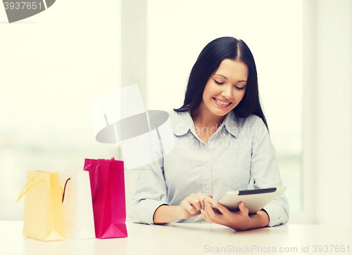 Image of smiling woman with blank screen tablet pc