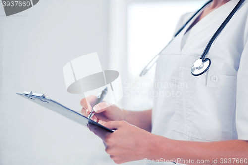 Image of female doctor with stethoscope and prescription