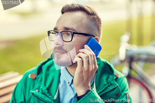 Image of young hipster man calling on smartphone