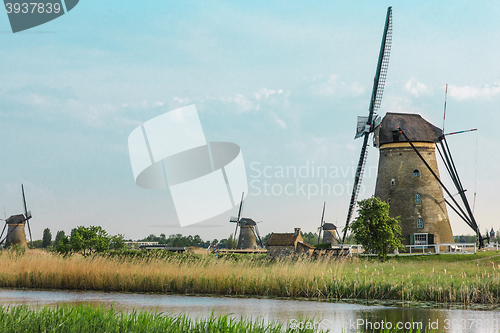 Image of Traditional Dutch windmills with green grass in the foreground, The Netherlands