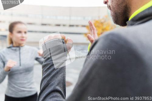 Image of close up of woman with trainer working strike out