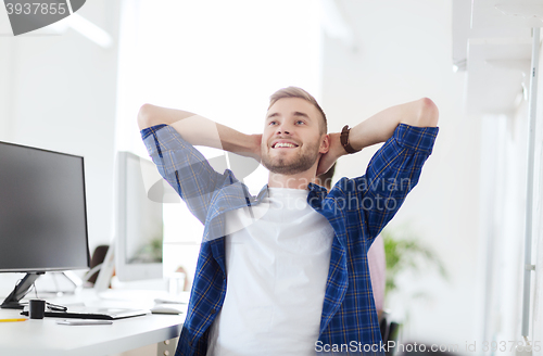 Image of happy creative man with computer at office