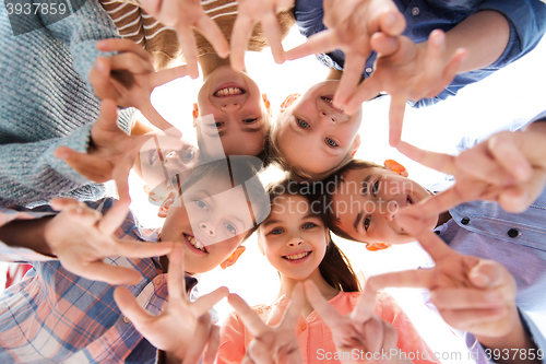 Image of happy children showing peace hand sign