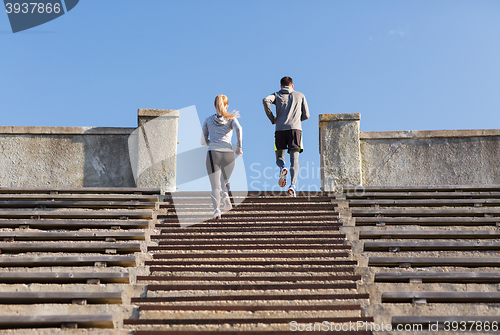 Image of couple running upstairs on stadium