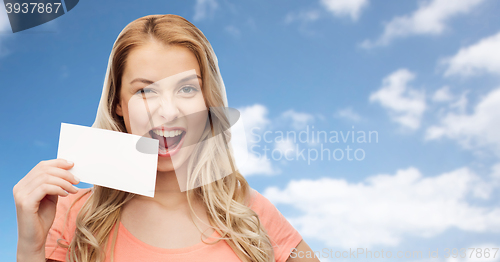 Image of happy woman or teen girl with blank white paper