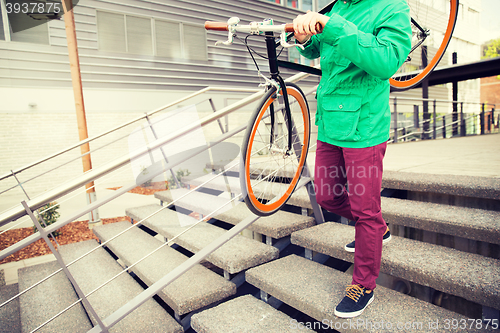 Image of man with fixed gear bike going downstairs