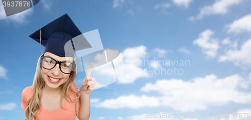 Image of smiling young student woman in mortarboard