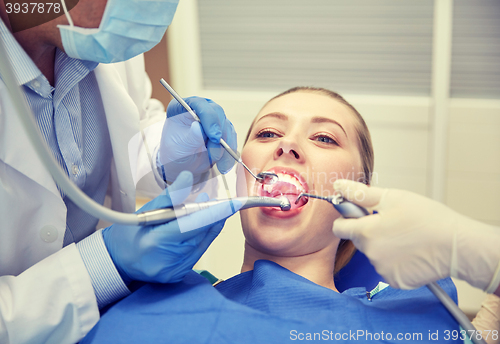 Image of close up of dentist treating female patient teeth