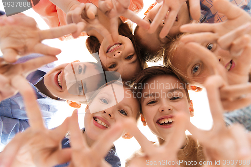 Image of happy children showing peace hand sign