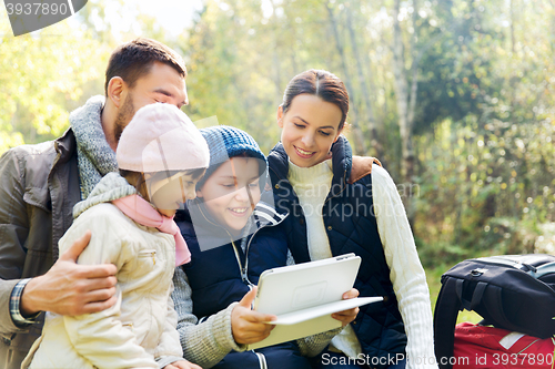 Image of happy family with tablet pc and backpacks at camp