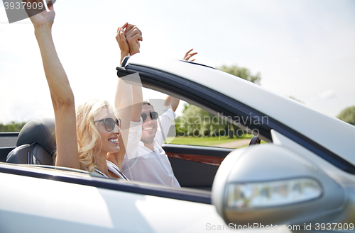 Image of happy man and woman driving in cabriolet car