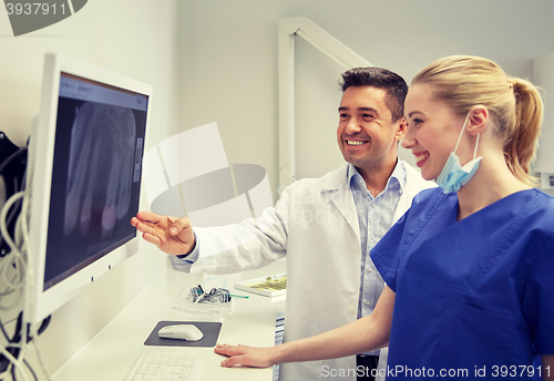 Image of dentists with x-ray on monitor at dental clinic