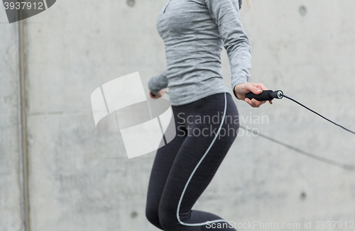 Image of close up of woman exercising with jump-rope