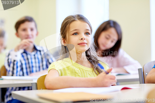 Image of student girl with group of school kids in class