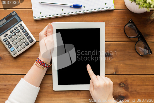Image of close up of woman with tablet pc on wooden table
