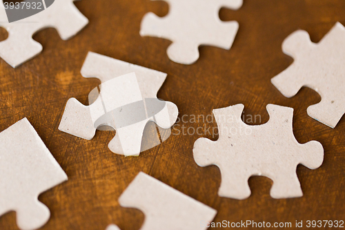 Image of close up of puzzle pieces on wooden surface