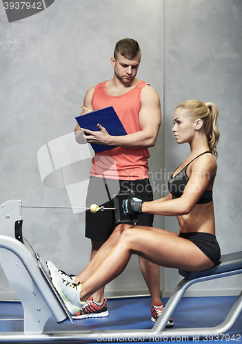 Image of man and woman flexing muscles on gym machine