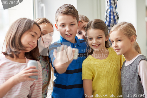 Image of group of school kids with smartphone and soda cans