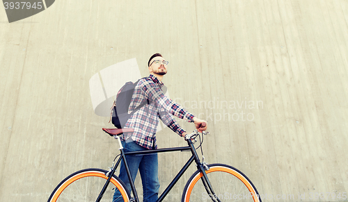 Image of hipster man with fixed gear bike and backpack