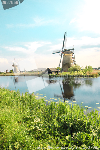 Image of Traditional Dutch windmills with green grass in the foreground, The Netherlands