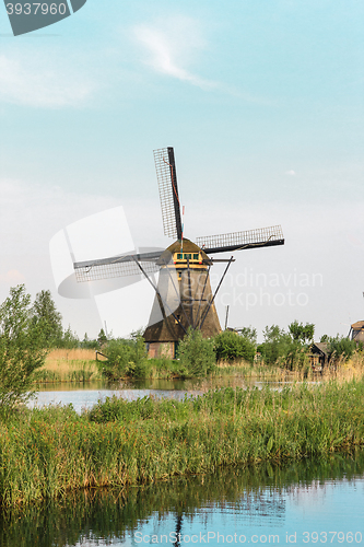 Image of Traditional Dutch windmills with green grass in the foreground, The Netherlands