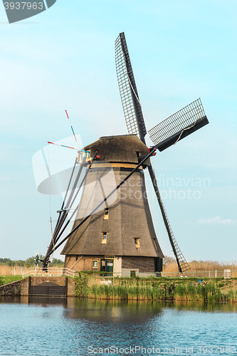 Image of Traditional Dutch windmills with green grass in the foreground, The Netherlands