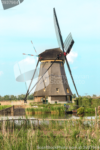 Image of Traditional Dutch windmills with green grass in the foreground, The Netherlands