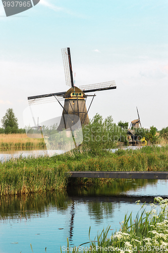 Image of Traditional Dutch windmills with green grass in the foreground, The Netherlands