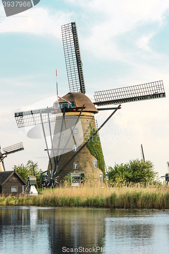 Image of Traditional Dutch windmills with green grass in the foreground, The Netherlands