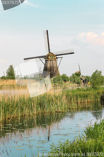 Image of Traditional Dutch windmills with green grass in the foreground, The Netherlands