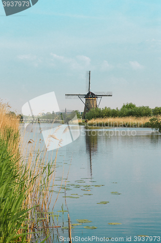 Image of Traditional Dutch windmills with green grass in the foreground, The Netherlands