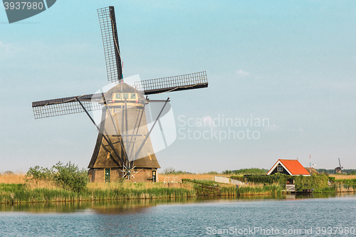 Image of Traditional Dutch windmills with green grass in the foreground, The Netherlands